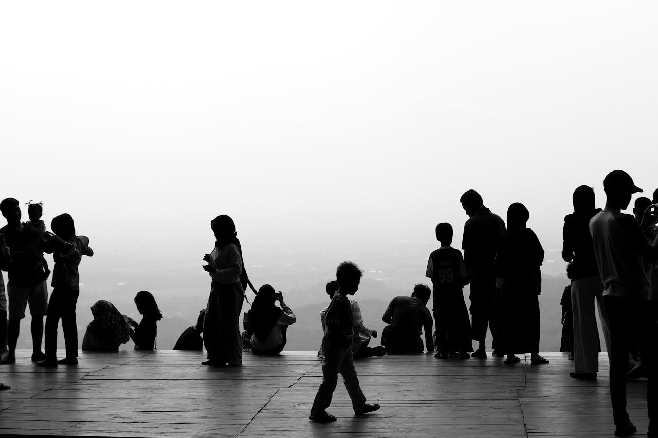 services-04 Monochrome silhouettes of people socializing on a scenic observation platform.